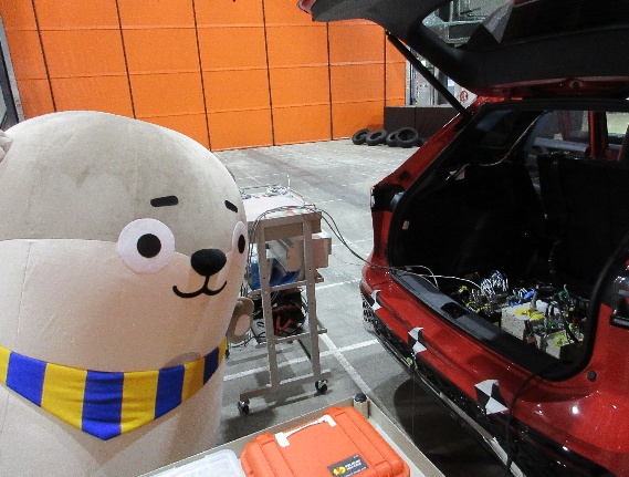 記録するための機器を車に乗せる様子